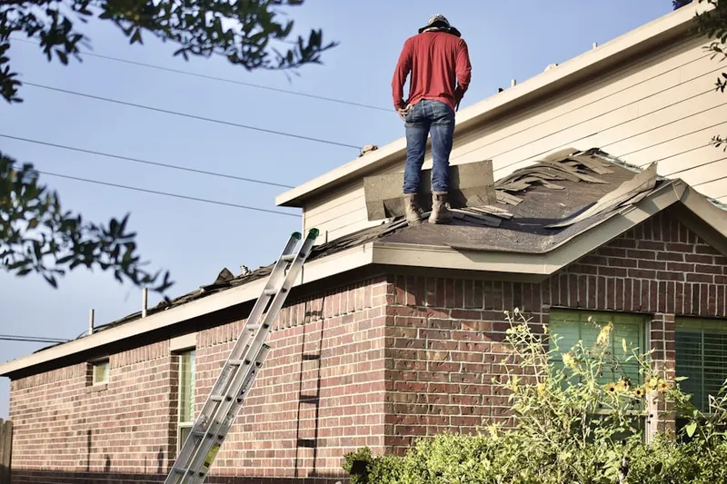 Professional roofer working on a residential roof in Oakcrest Estates